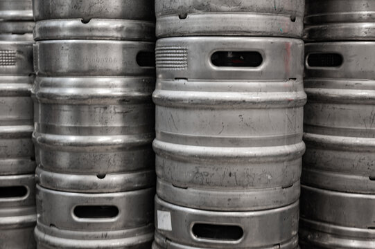 Range of stacked beer casks of kegs in brewery.
