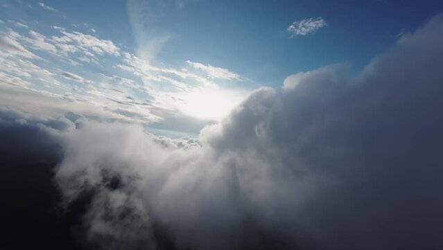 A unique view from the cockpit of a jet flying into cumulonimbus clouds at sunset. fpv fixed wing view. real flight in real clouds