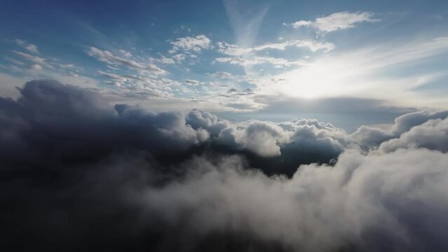 A unique view from the cockpit of a jet flying into cumulonimbus clouds at sunset. fpv fixed wing view. real flight in real clouds