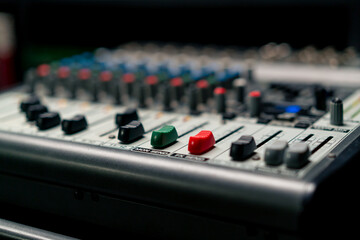 close-up of control buttons of a mixing console for recording soundtrack in a recording studio
