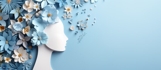 Blue background with paper human head and flowers symbolizing World Mental Health Day
