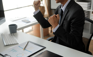 Close up Business woman using calculator and laptop for do math finance on wooden desk, tax, accounting, statistics and analytical research concept