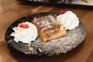 Tarte Pie Normande with apples, sliced almonds and sugar topped with creamy egg custard tart
