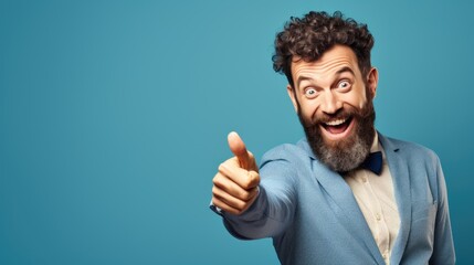 Excited man with beard giving thumbs up on a blue background.