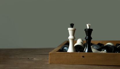 Vintage chess pieces, black and white queen on dark gray background. Chess sports wallpaper....
