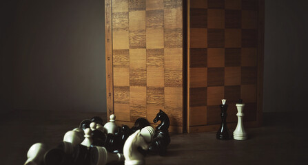 Vintage chess pieces and chess board on dark gray background. Blurry chess sports wallpaper....