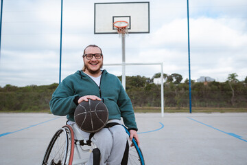 person in wheelchair looking at and smiling in basketball court outdoor