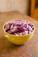 Sliced Red Onions in a Yellow Bowl