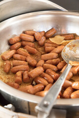 Sausage metal tray on buffet table at hotel breakfast food