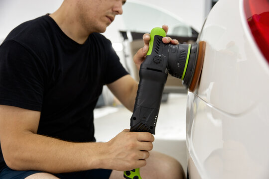 Closeup view on man car service worker applying special nano-ceramic polish cream