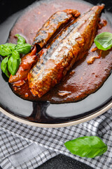 mackerel in tomato sauce and basil fresh canned fish delicious seafood healthy eating cooking appetizer meal food snack on the table copy space