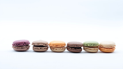 Close-up of some macarons, typical French desserts, white background