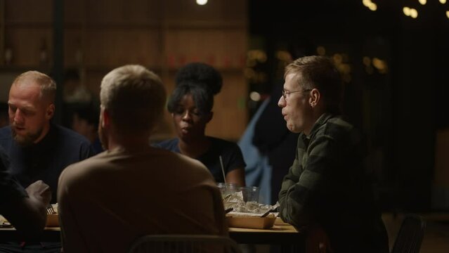 African American And Caucasian Young People Dining In Restaurant, Company Of Multiethnic Friends