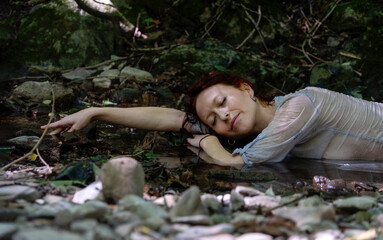 happy sexy sensual nature woman enjoying life lying in water of mountain stream