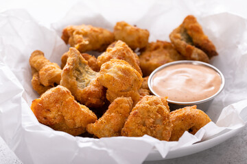 Catfish nuggets in a bowl with dipping sauce