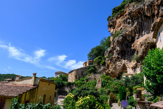 Travel destination, small ancient village Cotignac in Var, Provence, surrounded by vineyards and cliffs with troglodytes houses.