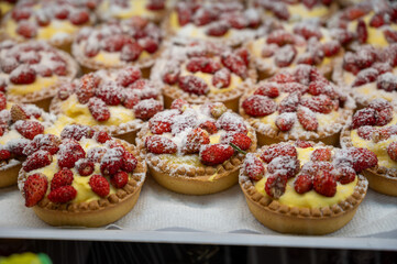 Wild fragolino strawberry and raspberry cakes in ancient city of strawberry Nemi, Castelli Romani, Italy close up