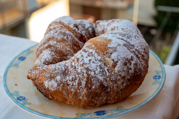 Italian sweet breakfast, fresh baked croissant buttery pastry with sugar powder