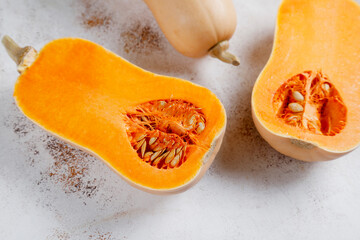 Halves of raw pumpkin or butternut squash.