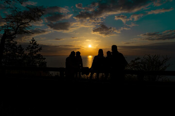 Family watching the sunset at seaside
