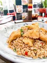 Peruvian traditional food chaufa rice with Fried Fish and spices. delicious