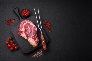 Fresh juicy raw beef striploin steak with salt and spices