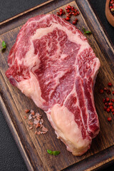Fresh juicy raw beef striploin steak with salt and spices