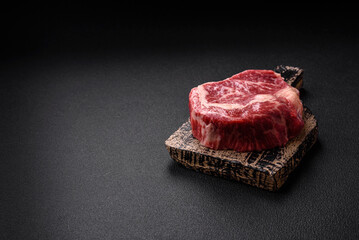 Fresh juicy raw beef striploin steak with salt and spices