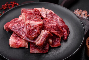 Fresh juicy raw beef slices with salt and spices
