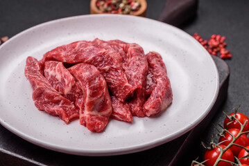 Fresh juicy raw beef slices with salt and spices