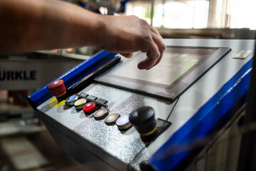 Modern timber processing facility with automated machines and stacks of wooden planks in large industrial warehouse