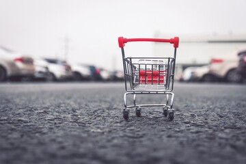Shopping Cart or Shopping Trolley leaved at car parking lot of supermarket. Customers use cart to...