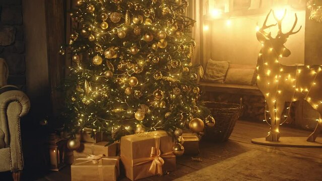 Christmas and New Year interior decoration. Green tree decorated, flashing garland, illuminated lamps. Fireplace and xmas tree. Cozy Christmas atmosphere. 4K