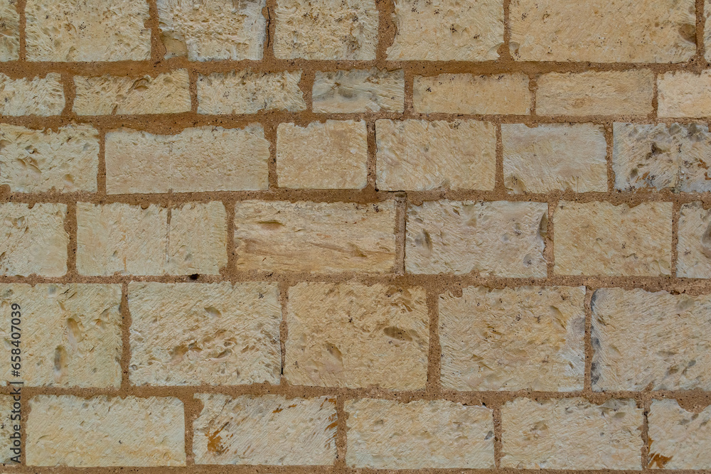 Poster surface made of regular rectangular stone blocks