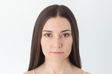 portrait of a young pretty Caucasian brunette woman before and after using eyebrow styling gel. Beauty and self-care. Isolated on a white background - obrazy, fototapety, plakaty