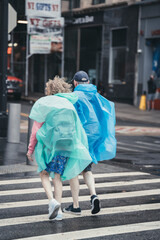 old couple walking in the street rain day New York  