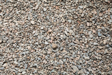 Little pebbles laying on the ground texture background