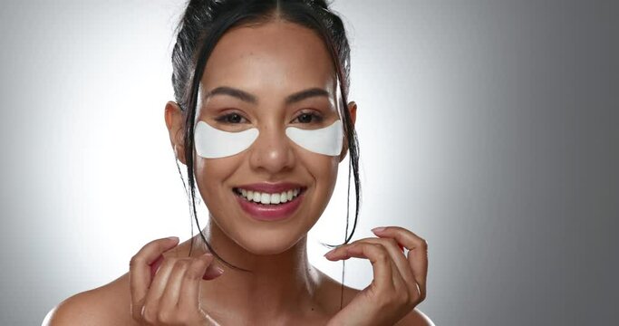 Woman, eye and patch for treatment in studio, face and mockup for skincare on gray background. Female model, person and smile with product for beauty with glow, hydration or moisturizer in anti aging