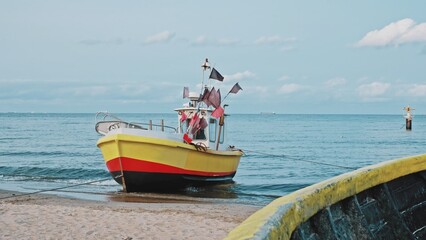 Naklejka na ściany i meble Undecked Handliner Fishing Vessel with Net Flags and Rusty Hooks Purse Sein Equipment Parked on Beach Sand at Seashore on Calm Day
