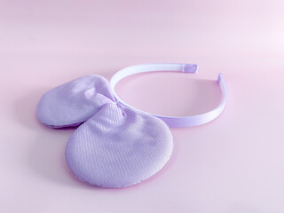 Purple mouse ear headband isolated on pink background