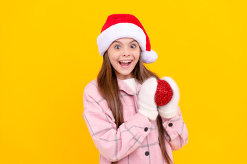 amazed teen girl in santa hat and mittens hold christmas decorative snowball, santa.