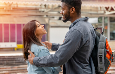 a young beautiful couple embraces on the platform meeting, saying goodbye the spouse, friend. Travel lifestyle concept