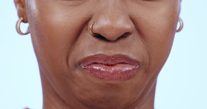 Mouth, gross and disgust with a woman closeup in studio on a blue background to express her dislike. Face, nose and bad aroma with a person smelling the awful scent of gas or bacteria in the air
