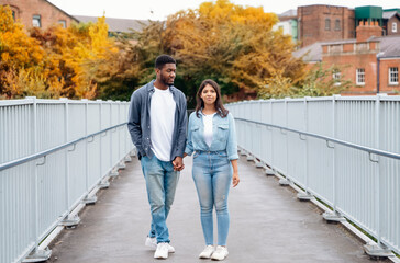 couple walking and hugging on the quays, pier, looking at yacht, sailboat, boat, having a fun,...