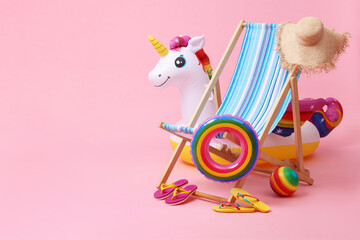 Deck chair, flip flops and other beach accessories on pink background, space for text. Summer...