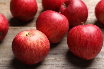 Fototapeta na wymiar Fresh red apples on wooden table, closeup