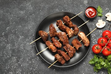 Delicious shish kebabs served on grey textured table, flat lay