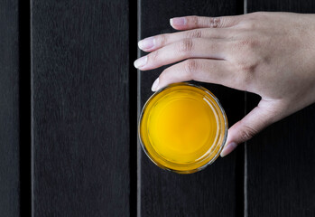 Hand holds orange juice