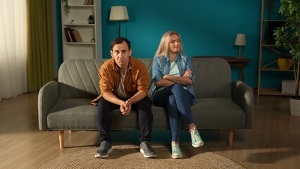 Portrait of a married couple sitting on a couch in a psychotherapy session. Fatigue, stress and...