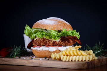 Chicken burger with lettuce, tomato, cheddar cheese and onion